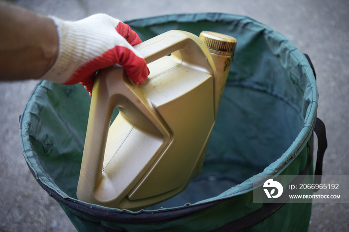 Throw an empty bottle of engine oil in the trash.Recycling of plastic waste. Oil waste.