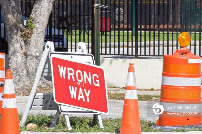 Orange traffic cones and Wrong Way Sign,Red background with white letters