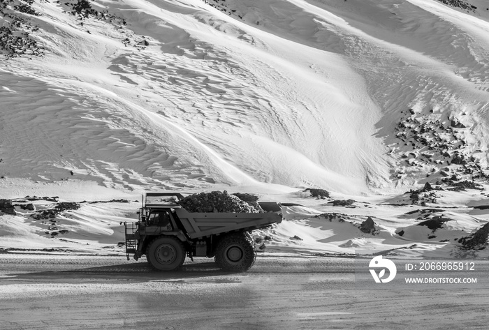 Ore laden haul truck in extreme conditions (black and white)