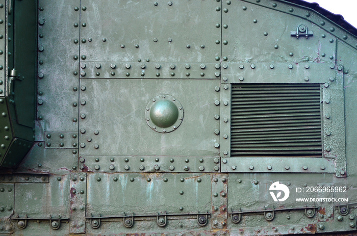 Texture of tank side wall, made of metal and reinforced with a multitude of bolts and rivets