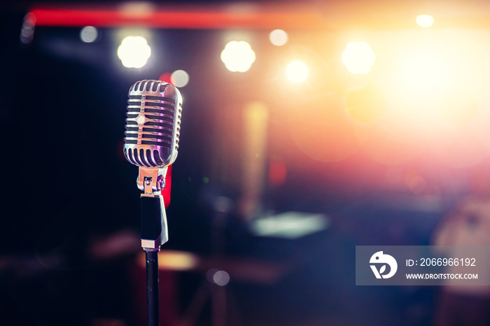 Close-up old retro vintage microphone on tinted color background copy space