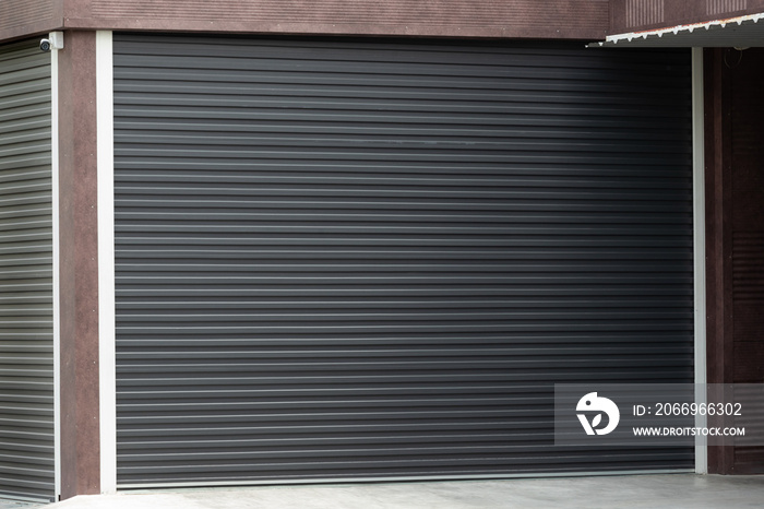 black steel shutter door of garage. metal curtain door of factory.