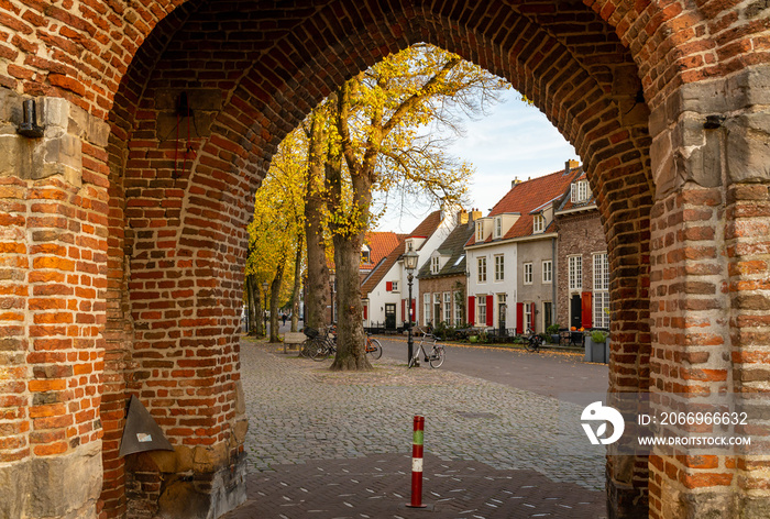 Peek through the arch of Vischpoort, the 14th century city gate in Harderwijk, Province Gelderland