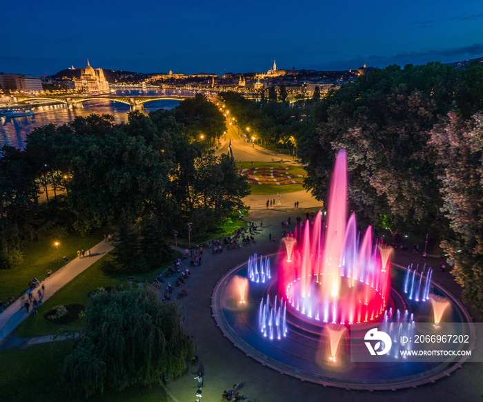 Budapest, Hungary - Aerial view of the Margaret Island Musical Fountain at dusk with Parliament building, Fisherman’s Bastion and Buda Castle Royal Palace at background