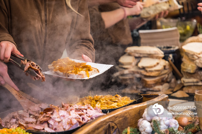 Food booth selling traditional Polish street food in Main Square, Kraków at Christmas market.