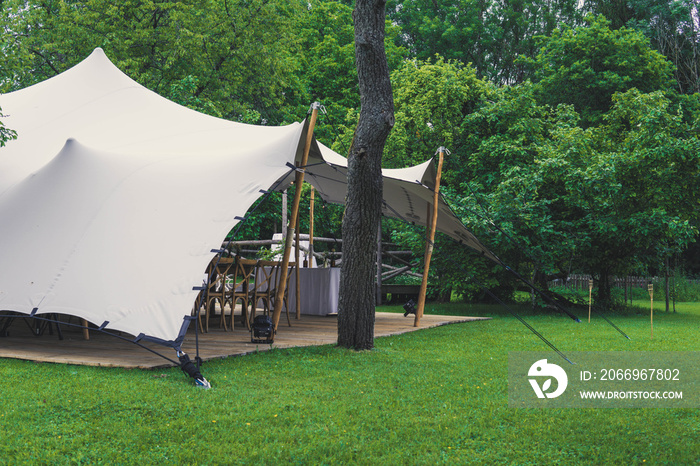 Image of huge tent for a wedding event in the nature