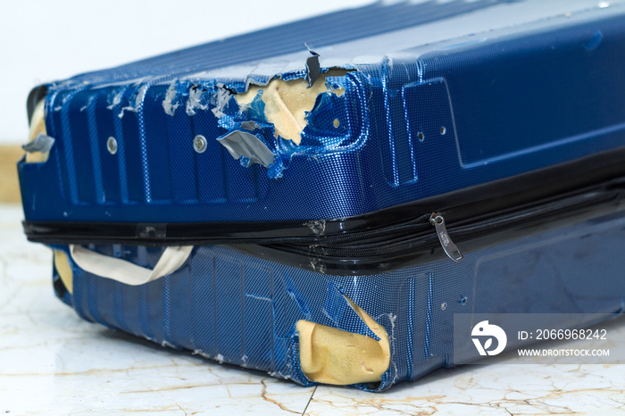 Traveling suitcase damaged at the airport. Broken luggage wheel