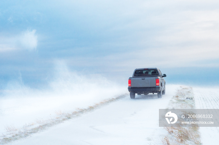 Pick-Up Truck on road in winter with heavy wind