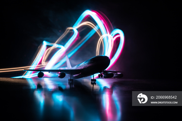 Artwork decoration. White passenger plane ready to taking off from airport runway. Silhouette of Aircraft during night time.