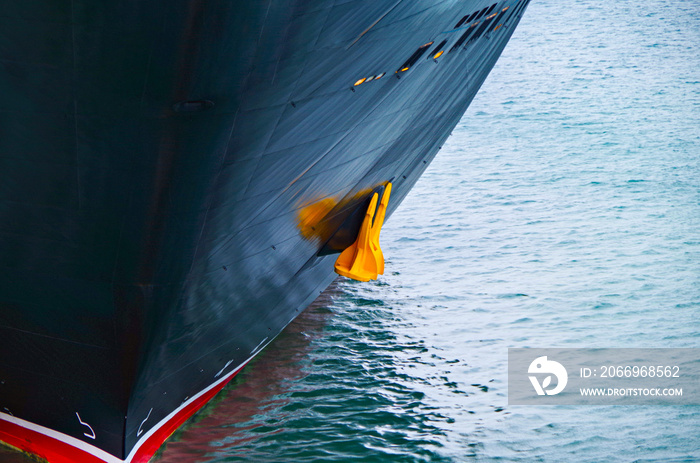 Close up of bow of modern Disney Cruise Line cruiseship or cruise ship liner Disney Dream or Disney Fantasy with anchor in blue, yellow and white