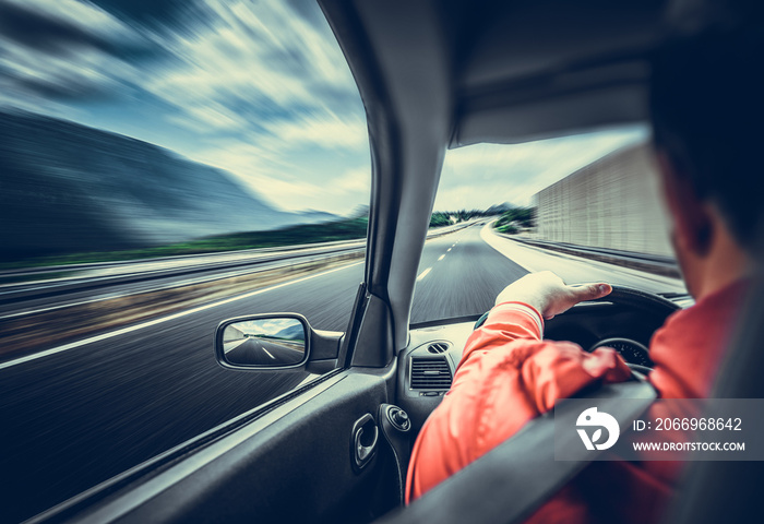 The driver of the car rushes along the highway. View from the inside of the car cab.