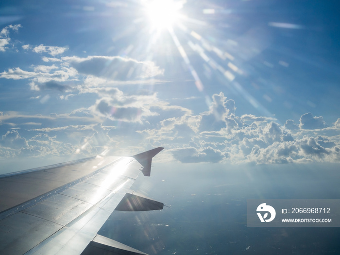 Sun light and air plane wing in the sky