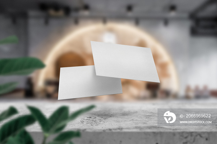 Clean minimal business card mockup floating on top table in lighting cafe