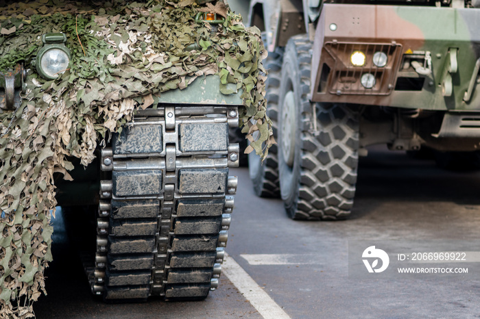 NATO response force or North Atlantic Treaty Organization armored crawler tanks and other military vehicles on the road, close up