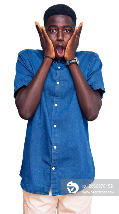 Young african american man wearing casual clothes afraid and shocked, surprise and amazed expression with hands on face