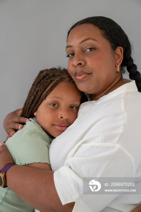 Mother embracing daughter (6-7)