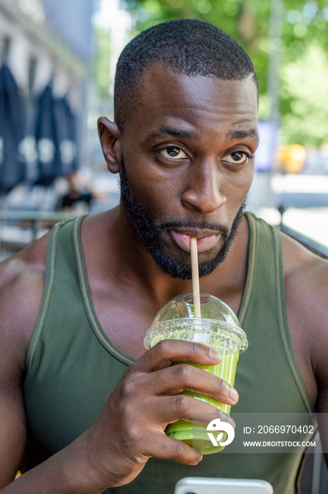 Mid adult man drinking smoothie