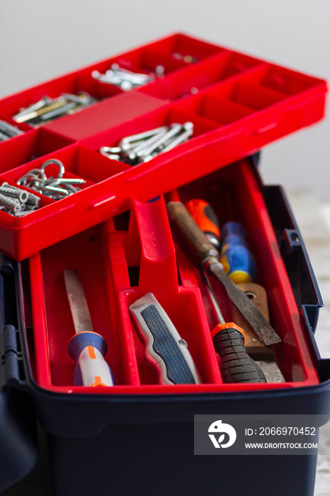 A professional toolbox full of screws of different types