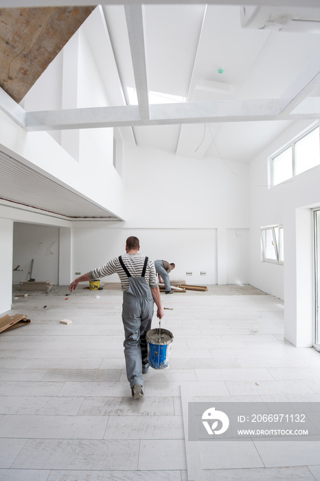 workers installing the ceramic wood effect tiles on the floor