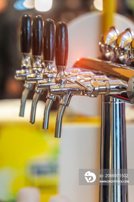 Draught beer taps in a bar.