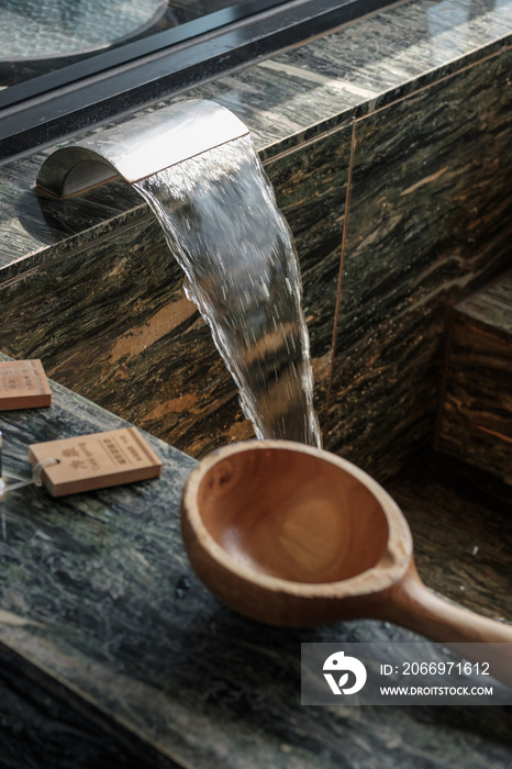 Luxury hot spring tub in hotel room in Taiwan with two hot spring tubs for hot and cold springs, wooden bath ladle.