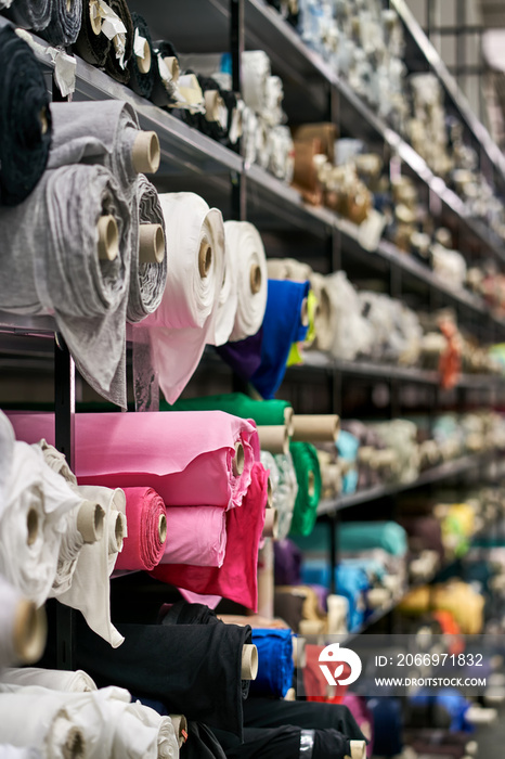 Fabric warehouse with many multicolored textile rolls