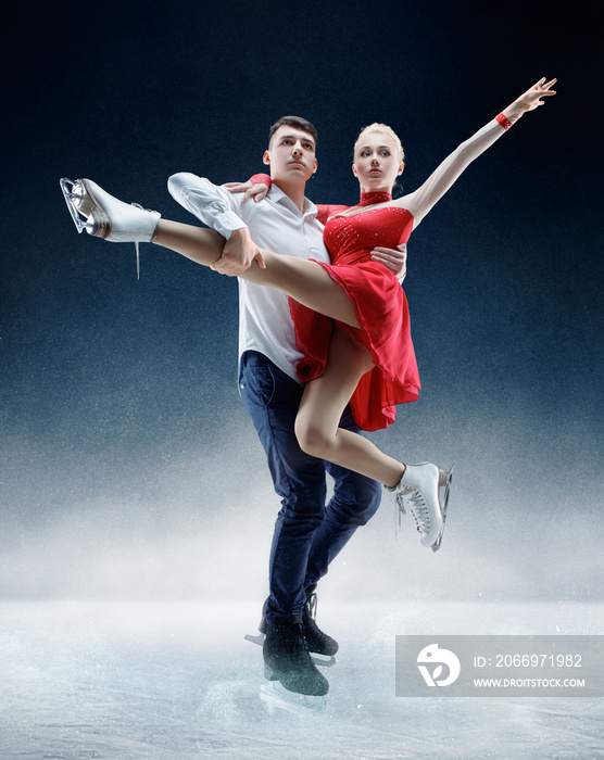 Professional man and woman figure skaters performing show or competition on ice arena