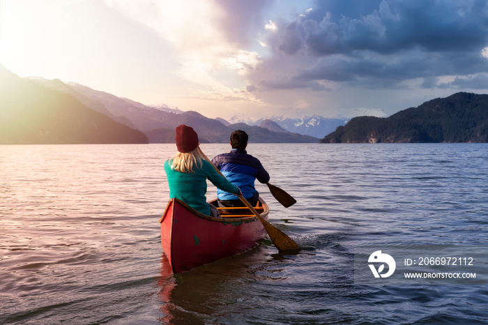 Couple friends canoeing on a wooden canoe during a sunny day. Colorful Sunset Sky Art Render. Taken in Harrison Lake, East of Vancouver, British Columbia, Canada.