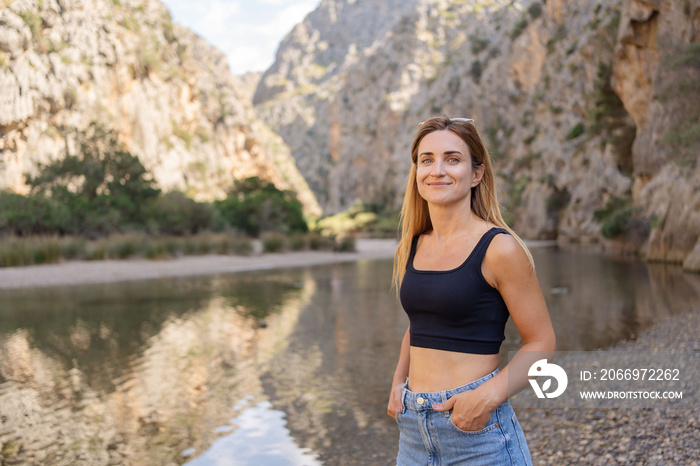 People enjoy view in canyon. Rocky mountains in the gorge and bay of Sa Calobra, Spain. Travel to Mallorca island