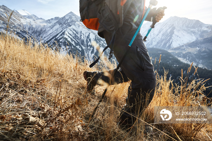 Hiker with backpack walking in the mountains