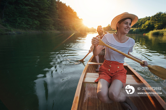 Happy couple enjoy boat ride on the sunset lake