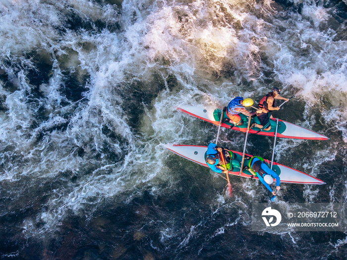 Guy in kayak sails mountain river. Whitewater kayaking, extreme sport rafting. Aerial top view