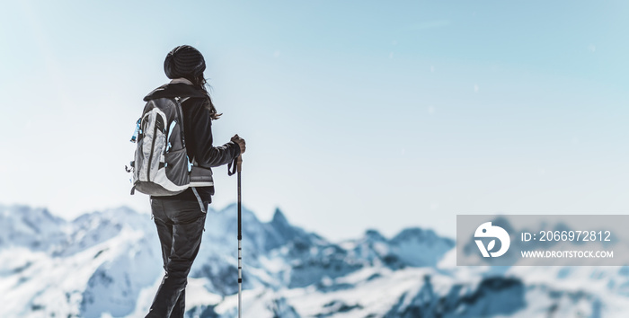 Athletic woman trekking in a winter landscape