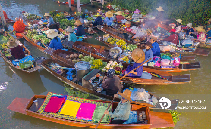 Damnoen Saduak Floating Market or Amphawa. Local people sell fruits, traditional food on boats in canal, Ratchaburi District, Thailand. Famous Asian tourist attraction destination. Festival in Asia.