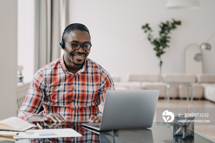 African american man teacher in headset gives online lesson at laptop. Elearning, distance education