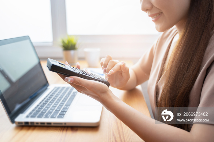 auditing company,business women financial inspector secretary do report about calculating,checking balance. Internal Revenue Service inspects checks document with a laptop computer and calculator.