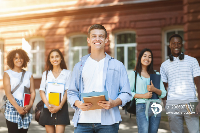 Student Leader Concept. Handsome Teen Guy Posing Outdoors Of University Campus