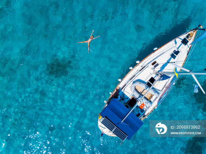 Aerial view to Yacht in deep blue sea. Drone photography