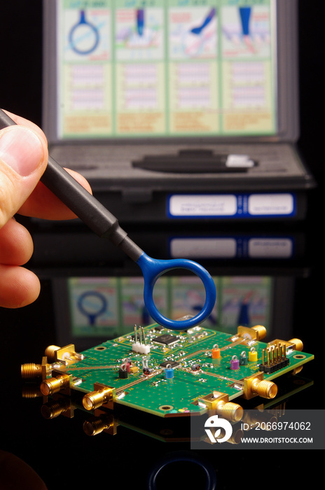 EMC engineer analyzing PCB using near-field probe