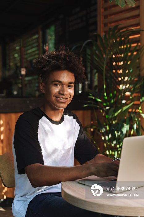 Young african teenager student sitting at the cafe