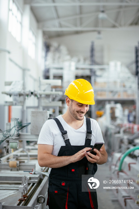 Factory worker in uniform with phone