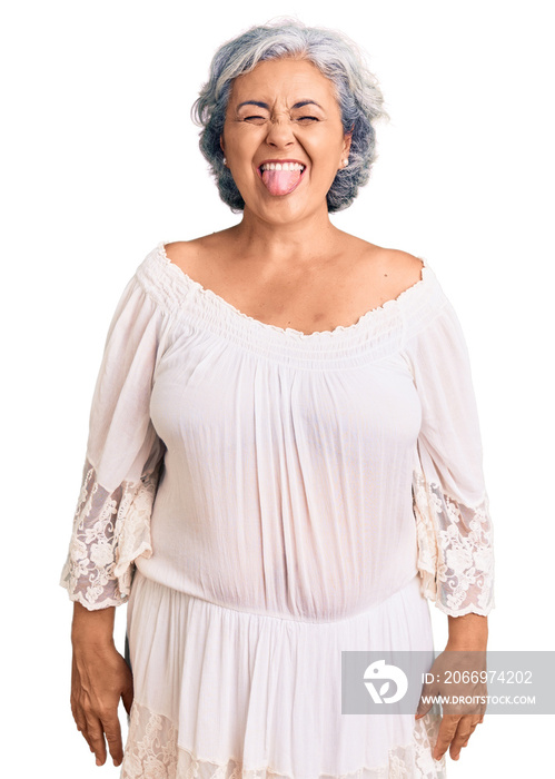 Senior woman with gray hair wearing bohemian style sticking tongue out happy with funny expression. emotion concept.