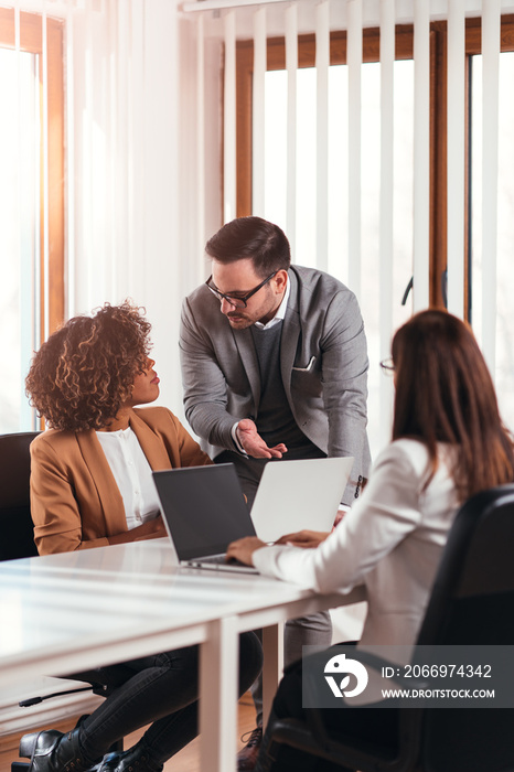 Worried businessman talking with female colleague during a meeting