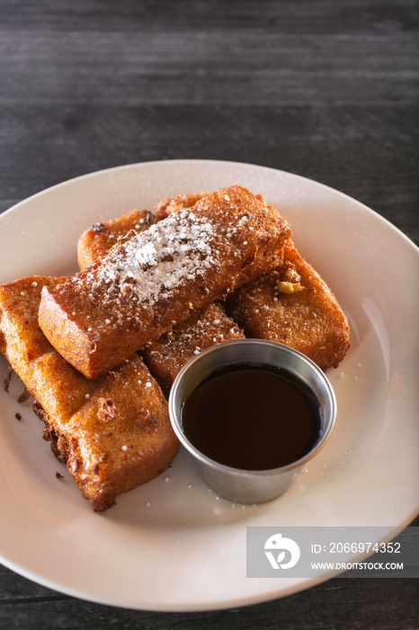 A view of a plate of French toast sticks.