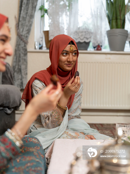 Women eating snacks during Ramadan celebration at home