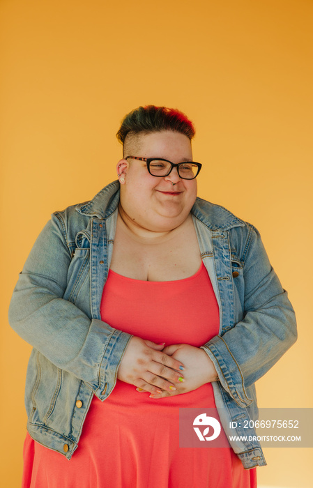 portrait of a plus size woman with rainbow short hair