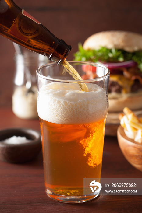 pouring india pale ale beer into pint glass and fastfood