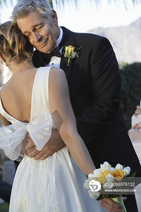 Emotional father hugging daughter on the day of wedding