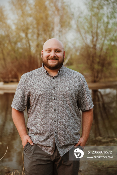 closeup of plus size bald man looking at camera