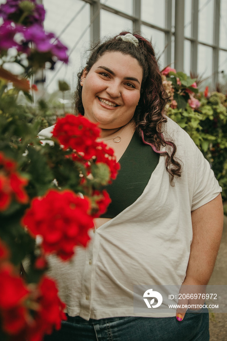 portrait of a plus size woman surrounded by flowers